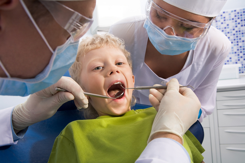 boy at dentist with tools