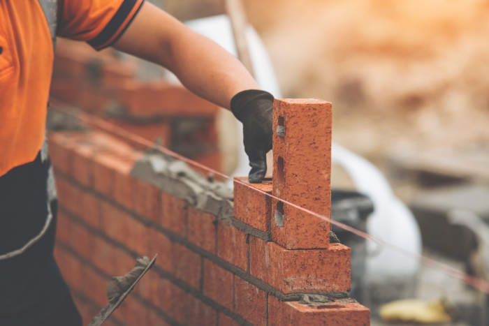 bricks being used to build a wall